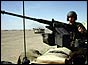 Soldier from British Tank Division patrols the desert north of Kuwait City