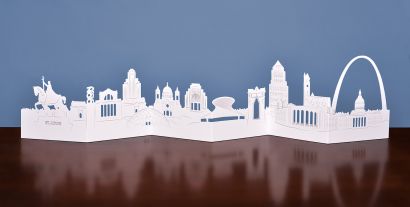 The folded out die-cut card of St. Louis's skyline