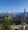 Le panorama de Berne montre l'imposante cathédrale qui se dresse devant le décor pittoresque des Alpes suisses, dans un moment de clarté paisible.