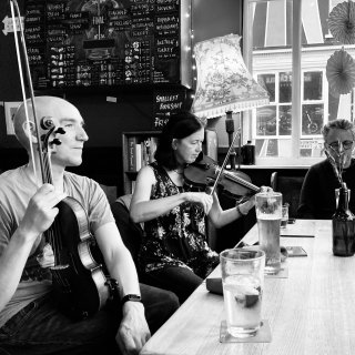 Fiddlers round a pub table.