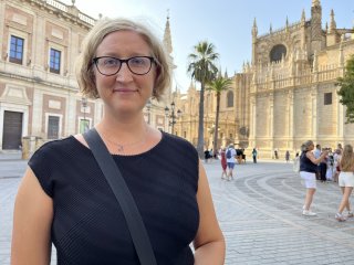 Jessica in a square by the ornate gothic cathedral.