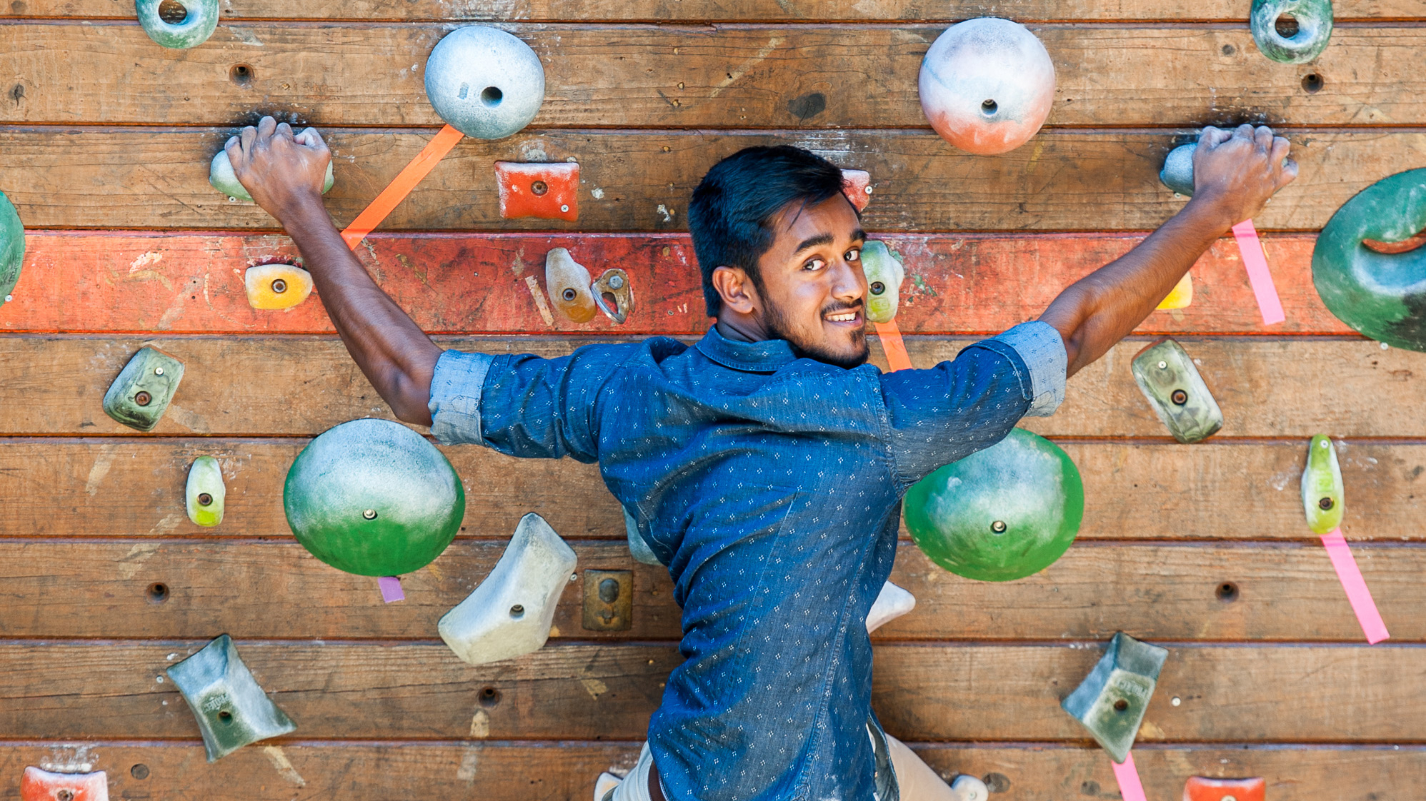 Student scaling a climbing wall 