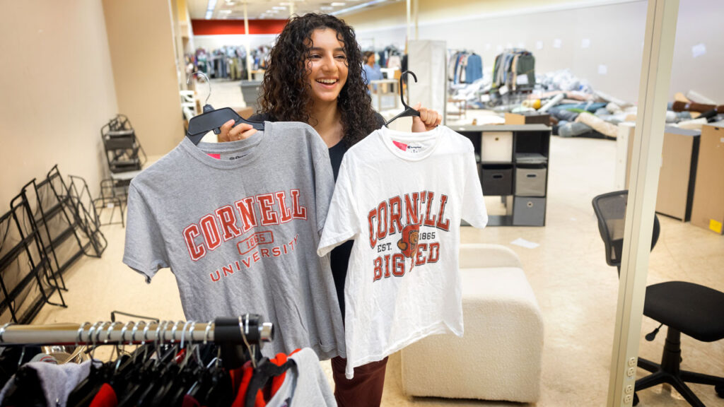 A shopper holds up two Cornell shirts at Dump and Run.