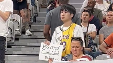 Fan holds Caitlin Clark sign at U.S. women's Olympic basketball game