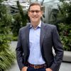 John Schoettler stands outside in front of the Amazon Spheres