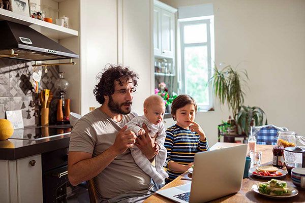 father-with-baby-looking-at-laptop