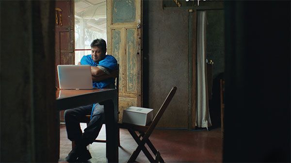 man-sitting-on-chair-in-front-of-laptop