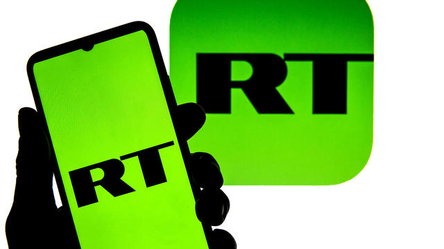 In this photo illustration a RT logo seen displayed on a 