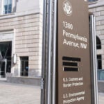 A street sign with names of US government agencies housed at the Ronald Regan Building, including the United States Agency for International Development, or USAID headquarters in Washington, is pictured with one building occupant taped, Friday, Feb. 7, 2025, in Washington.