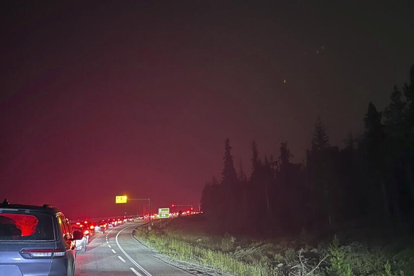 This photo provided by Carolyn Campbell shows cars clogging the highway as people evacuate because of wildfires early Tuesday, July 23, 2024, in Jasper, Alberta. Multiple wildfires in Canada’s Jasper National Park have flared up, forcing all park visitors along with the 4,700 residents of the Jasper townsite to flee. (Carolyn Campbell/The Canadian Press via AP)