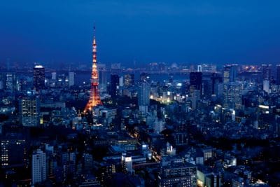 Evening view of the Tokyo skyline, which includes buildings, water and the Tokyo Tower