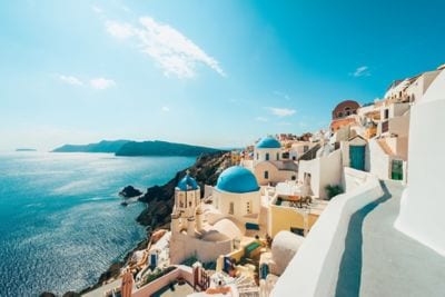 Whitewashed buildings line the seaside in Greece