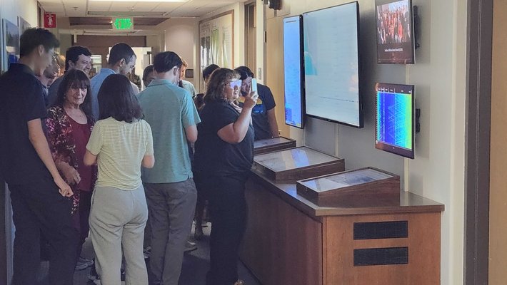 Caltech community members look at earthquake waveforms on display in the Seismo Lab after a magnitude 4.4 quake rattled campus