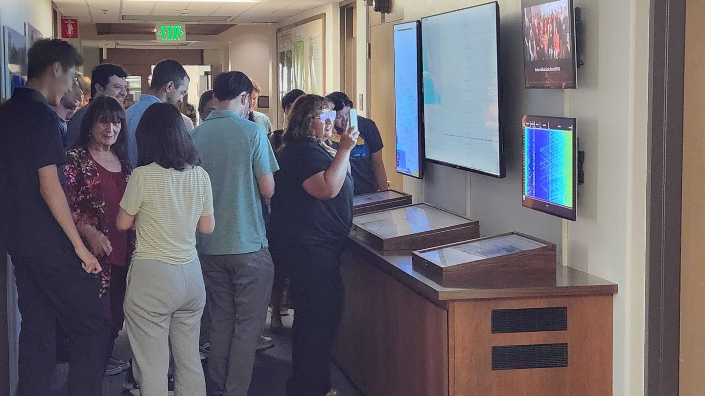 Caltech community members look at earthquake waveforms on display in the Seismo Lab after a magnitude 4.4 quake rattled campus