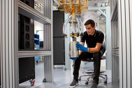 An AWS quantum hardware engineer works on a dilution refrigerator.