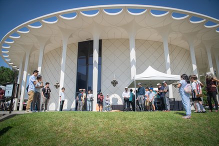 Caltech community members watching a demonstration of a robot in front of Beckman Auditorium.