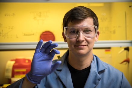 Graduate student Andrey Vyatskikh holding a polymer.