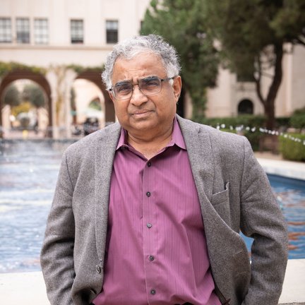 Shri Kulkarni standing in front of a fountain on Caltech campus.