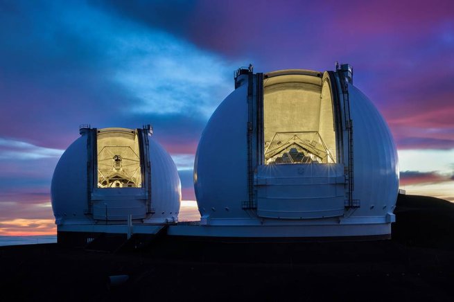 Twin Keck Telescopes with sunset in background.