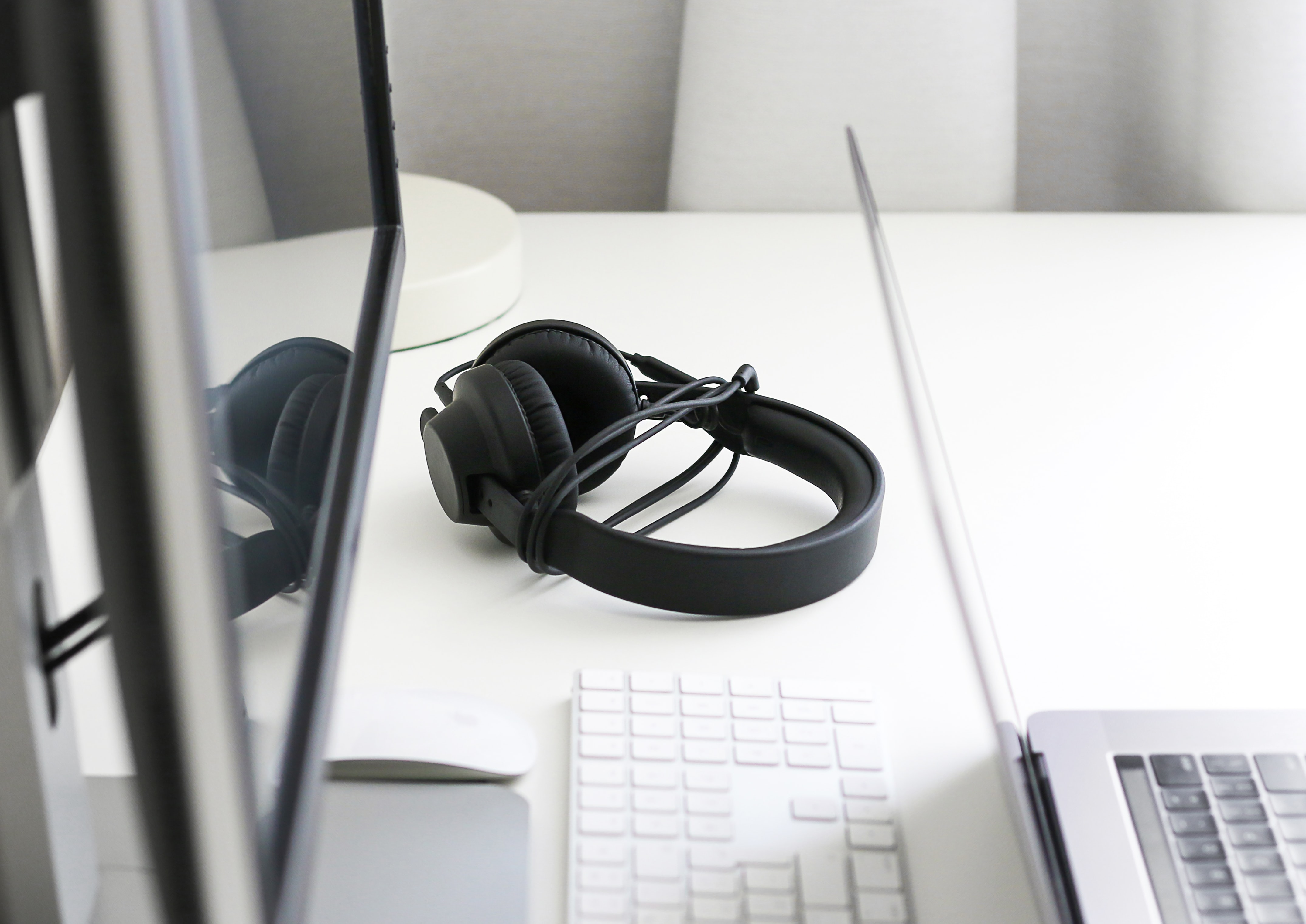 Computer desk with a pair of wired headphones