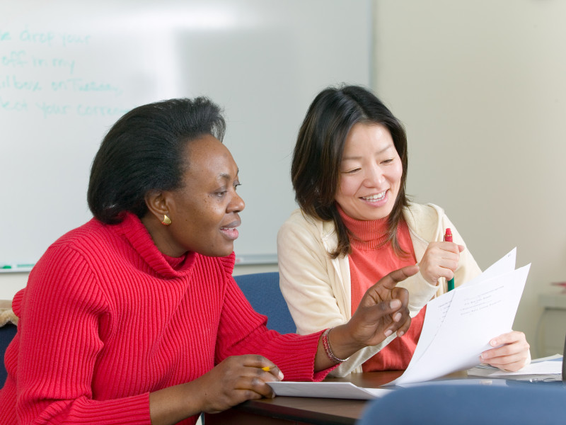 two people looking at a document