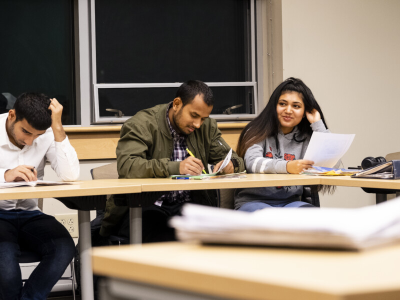 Three students studying at a table