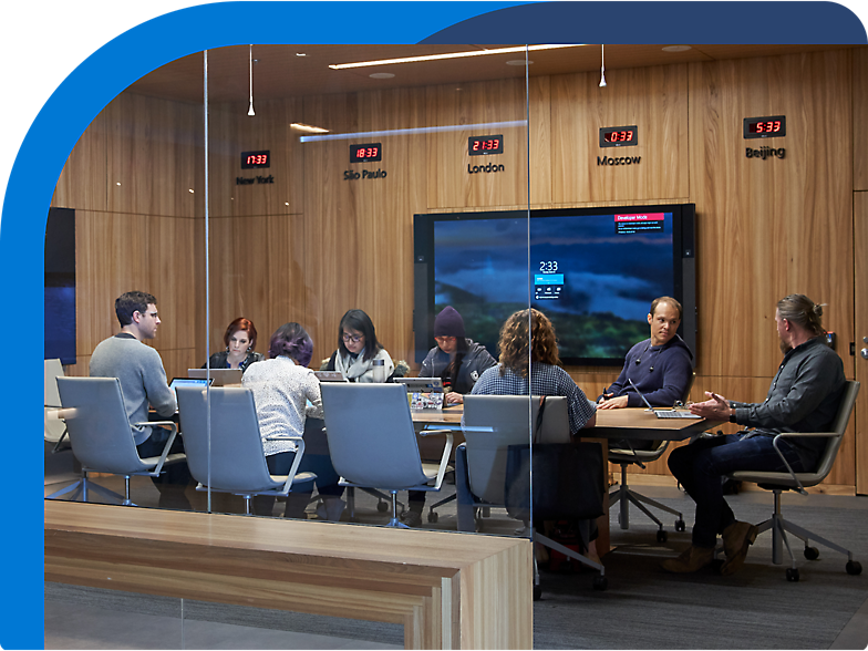 A group of people sitting around a table in a conference room.