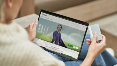 A person using a tablet for online shopping.