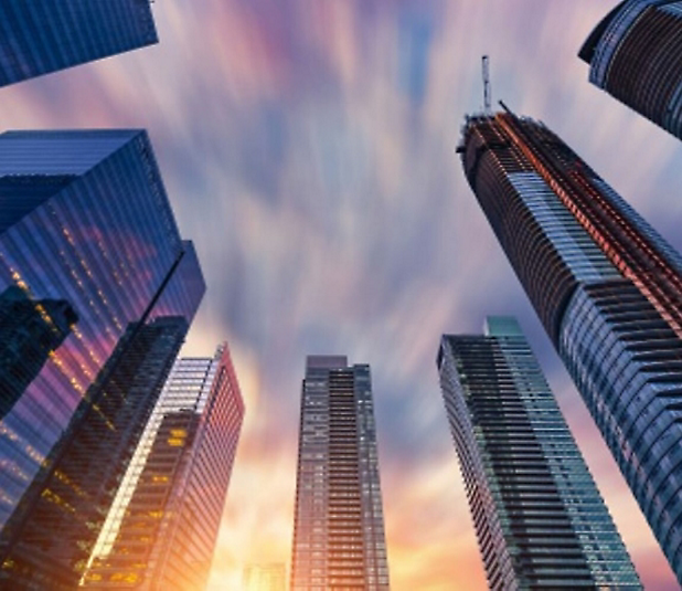 Skyscrapers in a city at sunset.