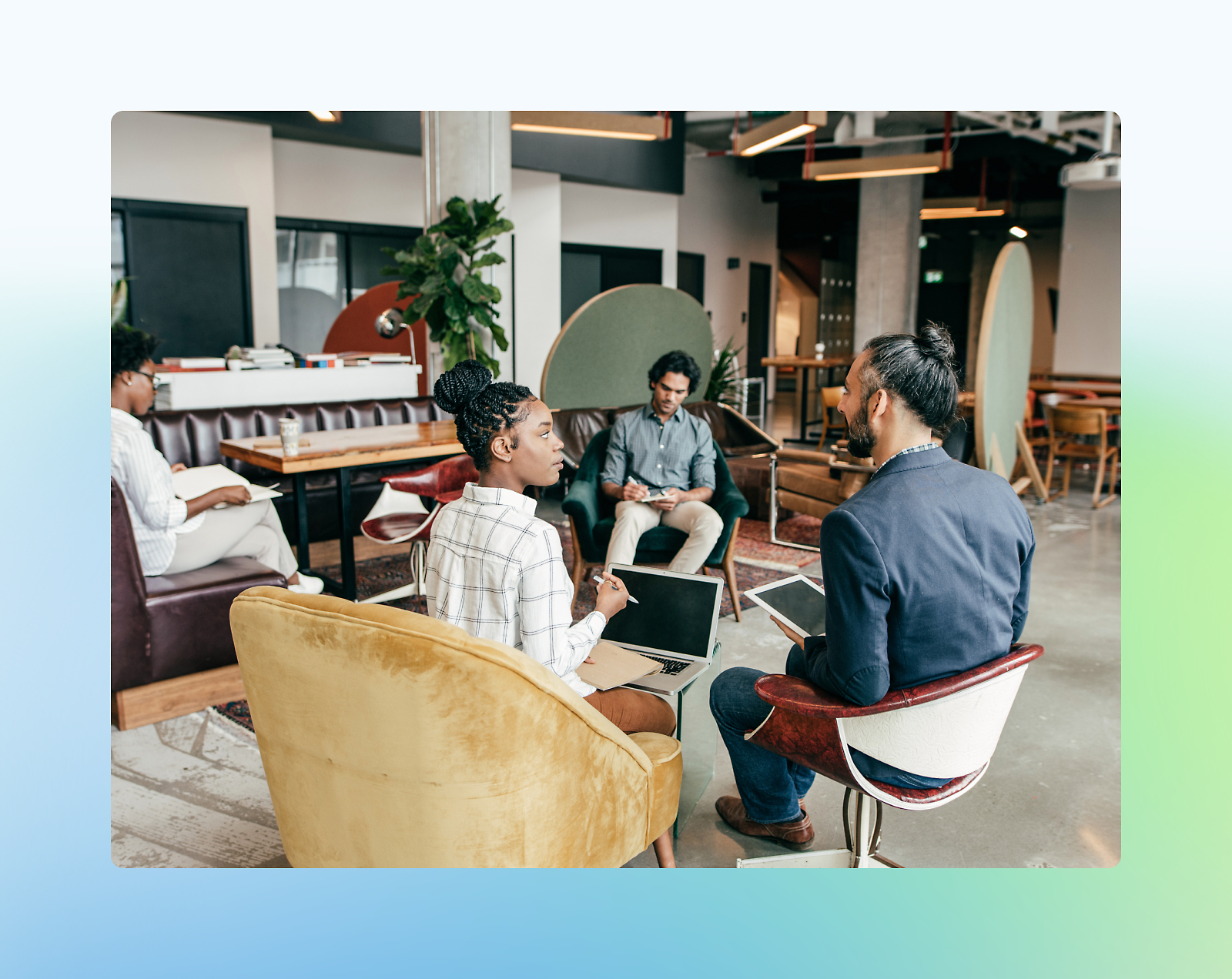 Group of professionals sitting in office chairs during a meeting.