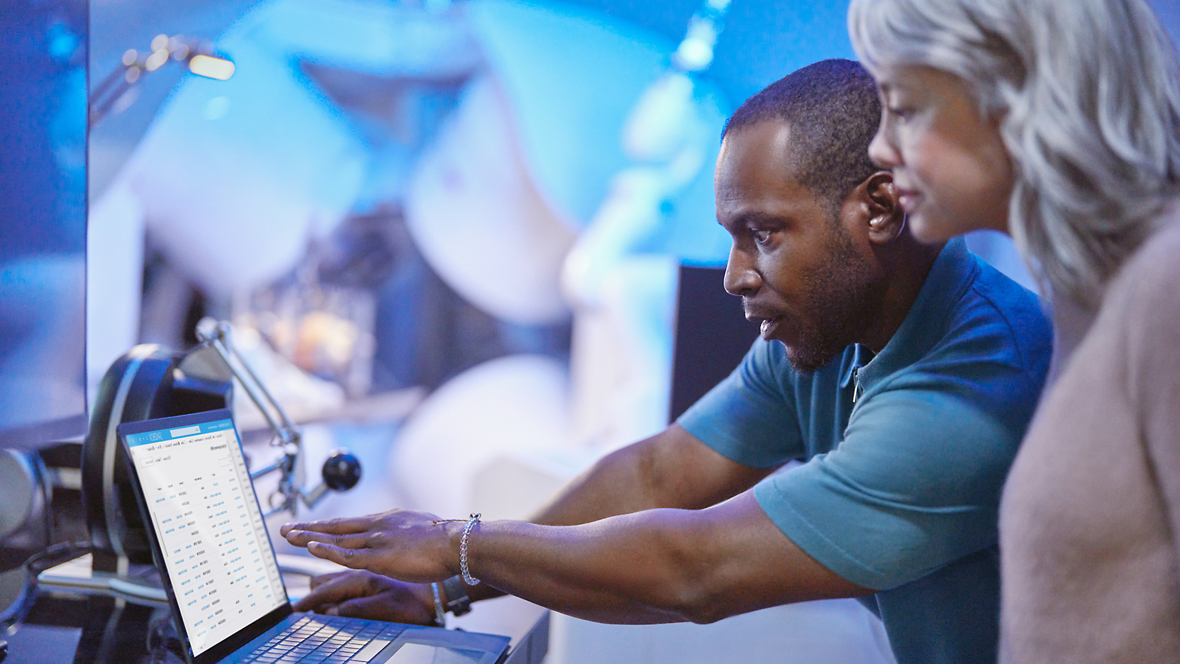 Two person's looking at a computer