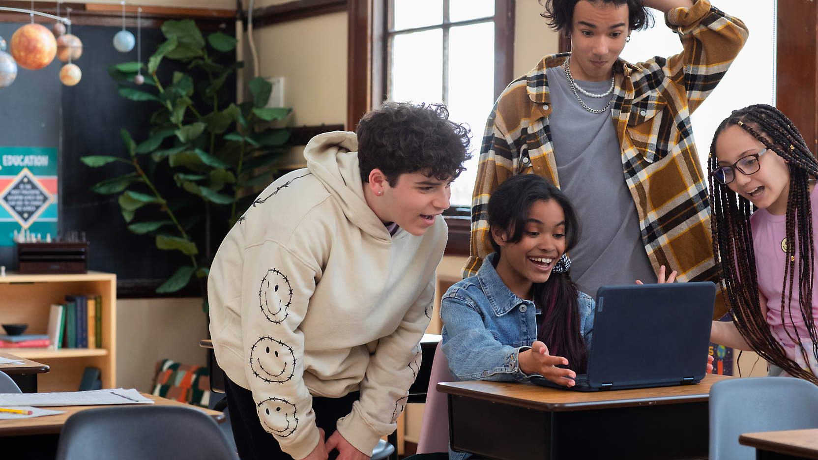 A group of people looking at a computer