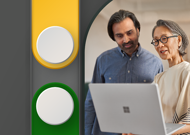 A man and woman looking at a laptop screen. 