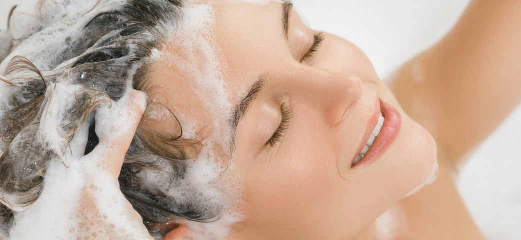 Woman washing soapy water in her hair-Caption “I’m Alive”