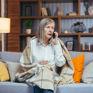 An older woman is talking on the phone. 