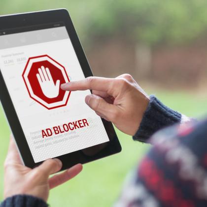 Man turning on ad blocker on his iPad