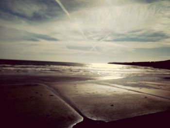 Scenic view of beach against sky during sunset