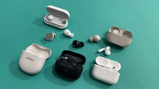 Bose, Sony, Apple and Bowers & Wolkins wireless earbuds lined up and out of their cases