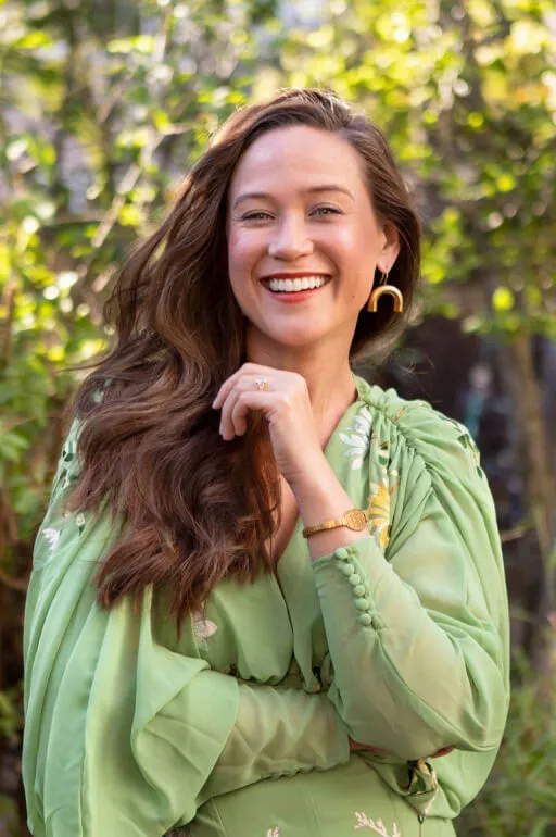 A woman poses for a picture and smiles