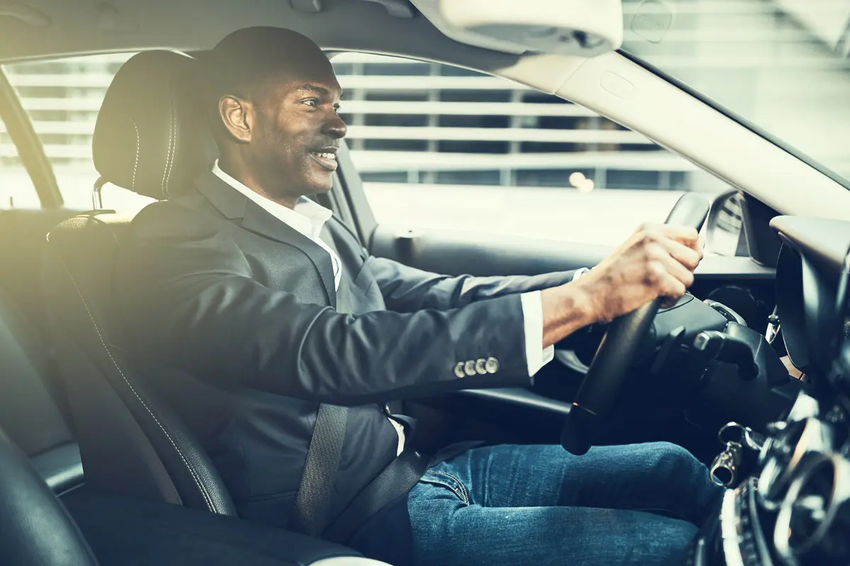 South african man in a grey suit practicing road safety