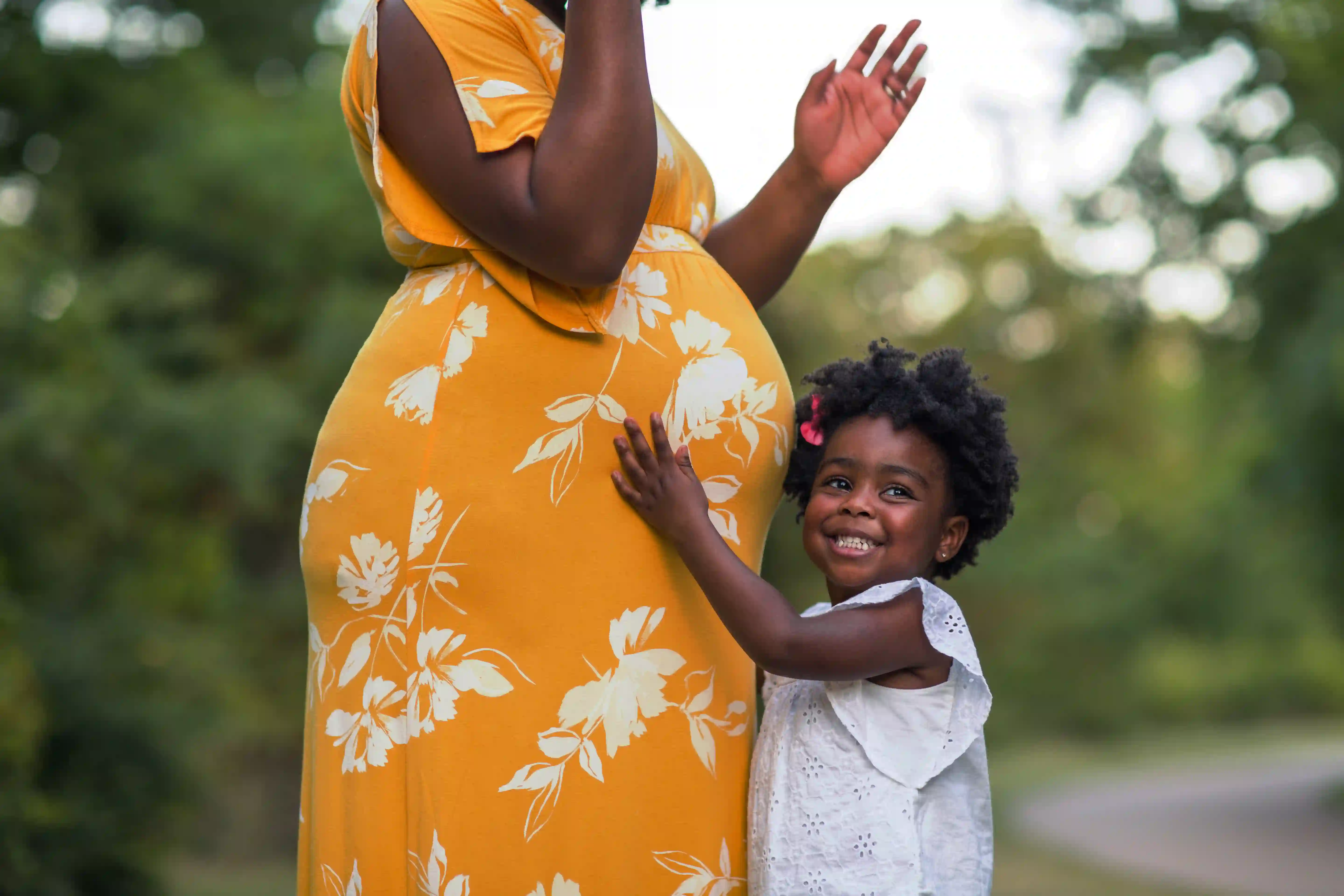 Pregnant south african woman hugs her child