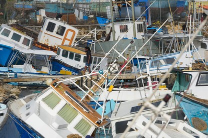 A fisherman looks at fishing vessels damaged by Hurricane Beryl at the Bridgetown Fisheries in Barbados on July 1, 2024.