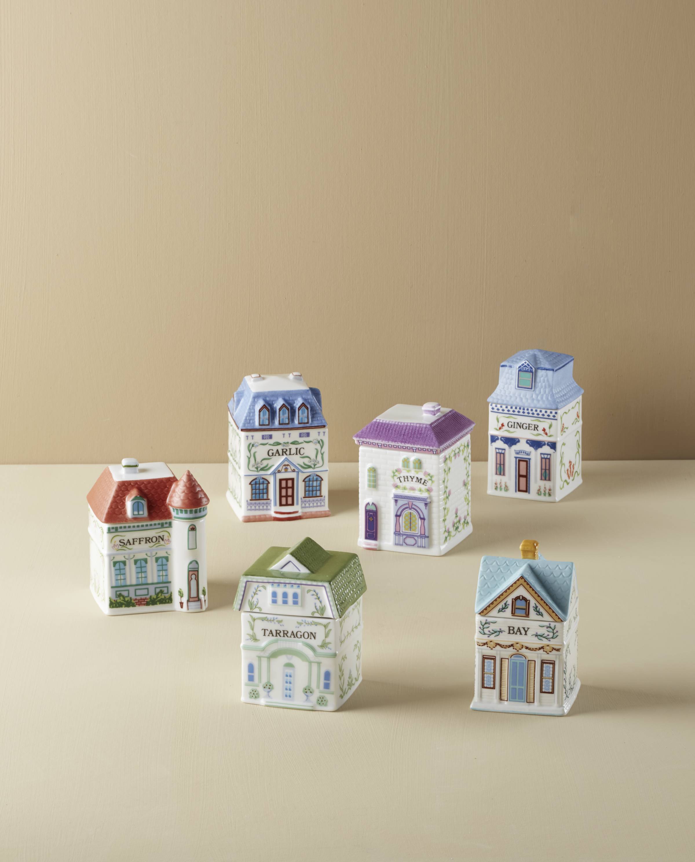 A set of six spice jars shaped like houses.