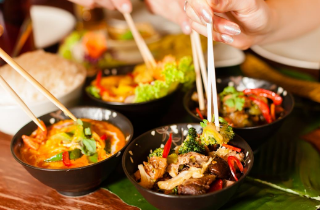 Food in bowl with chopsticks