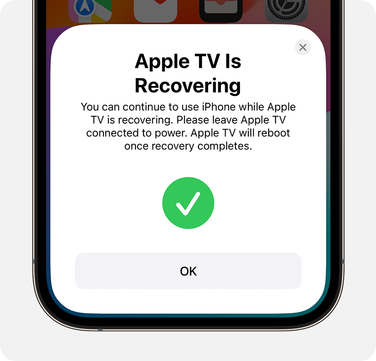 The Apple TV Is Recovering notification appears on iPhone.