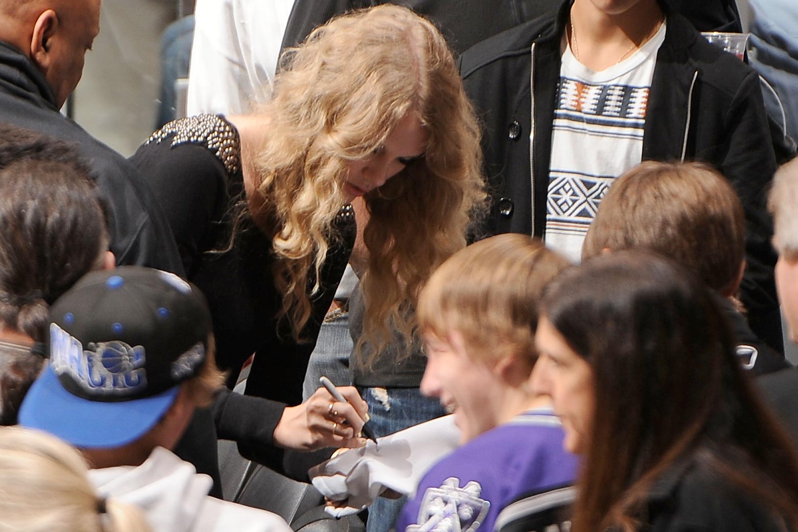 From 2009. She looks a little older but still has fairly curly hair and fairly sparkly clothes. In her hand, the claw grip.