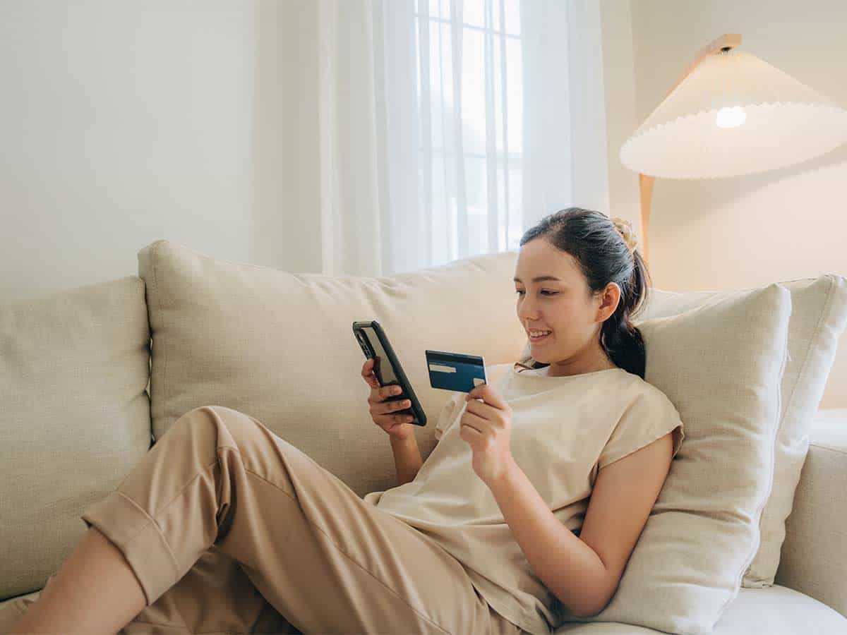 Woman using a Credit Card on her Phone