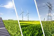 Solar panels, wind turbines and power-lines in green fields 