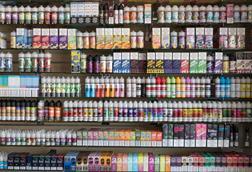 Different brands and flavours of vape juice on a shop shelf