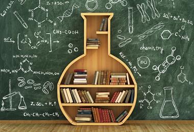 An image of a flask-shaped bookcase in front of a blackboard